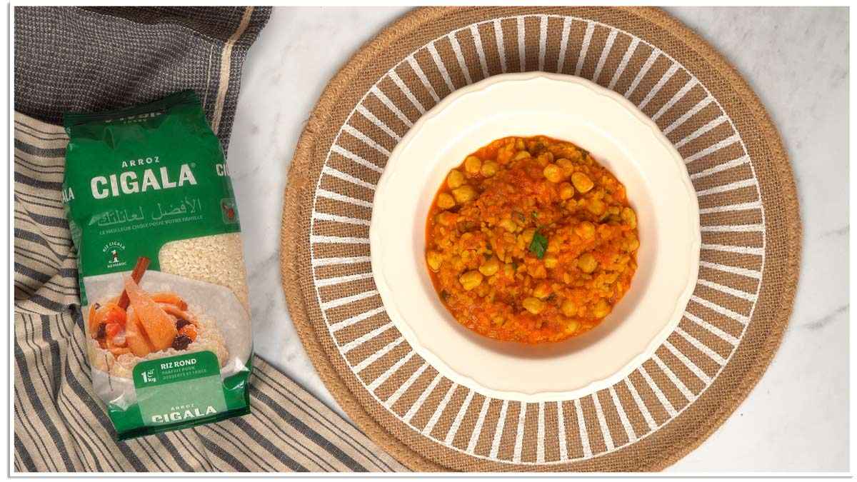 Finaliser et servir Un plat de riz aux pois chiches est servi dans une assiette blanche, prêt à être dégusté.