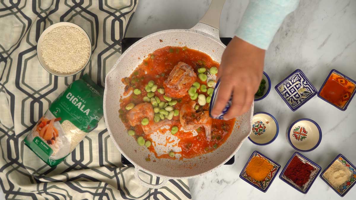 On incorpore ensuite la purée de tomates et les fèves fraîches à la viande pour créer une base savoureuse.
